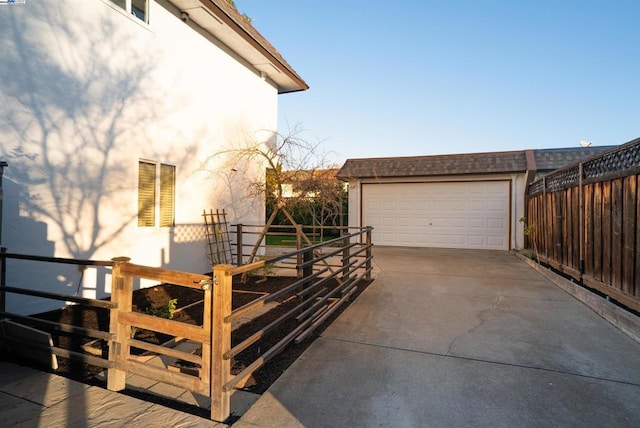 view of property exterior with an outdoor structure and a garage