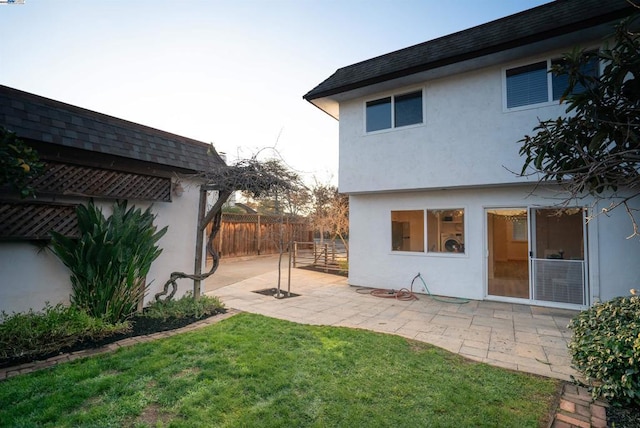 rear view of property with a patio area and a lawn