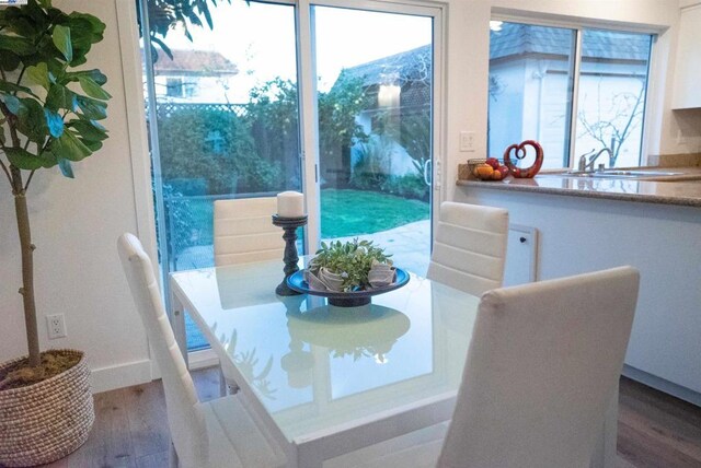 dining area with hardwood / wood-style flooring and sink