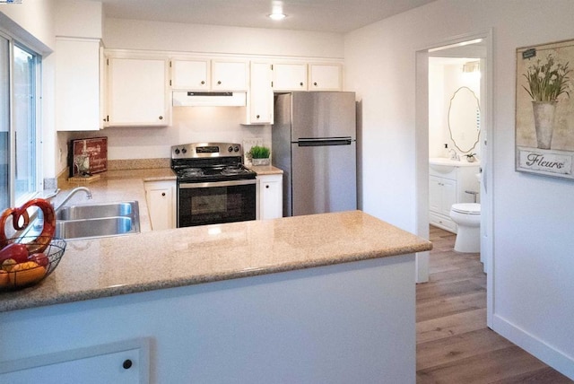 kitchen featuring light hardwood / wood-style flooring, sink, stainless steel appliances, and white cabinetry