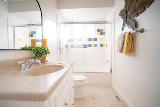 full bathroom with shower / bath combination with glass door, vanity, toilet, and tile patterned flooring