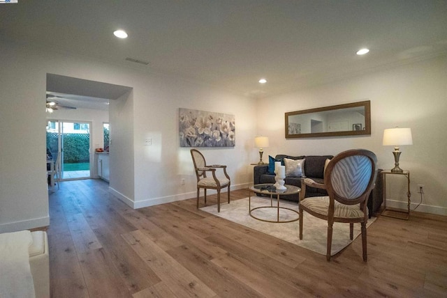 living area featuring ceiling fan and hardwood / wood-style flooring