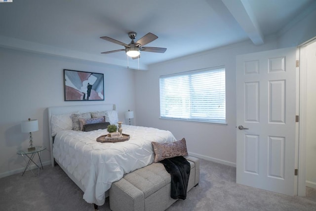 bedroom with ceiling fan, carpet floors, and beamed ceiling