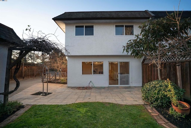 rear view of house with a patio