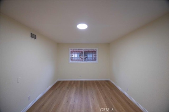 unfurnished room with light wood-type flooring