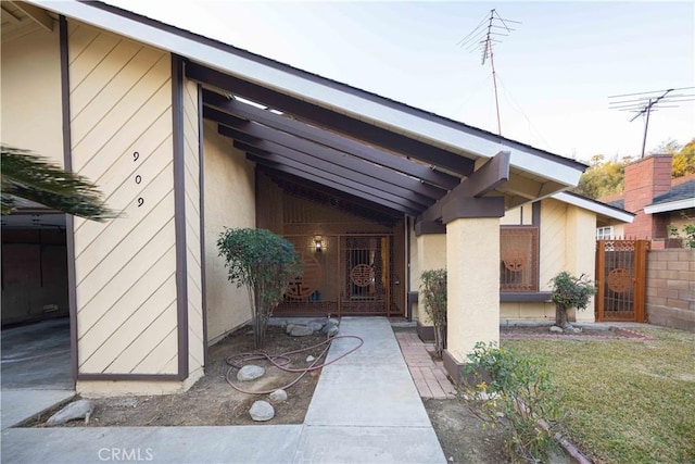 doorway to property with a lawn