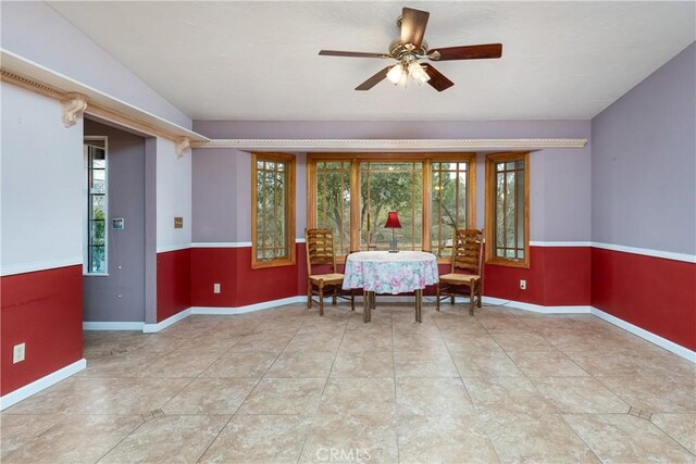 tiled dining space featuring ceiling fan