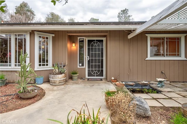 view of exterior entry featuring a patio area