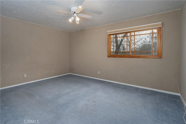 carpeted empty room featuring a textured ceiling and ceiling fan