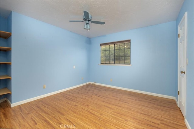 unfurnished room featuring ceiling fan and light hardwood / wood-style floors