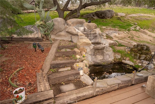 view of yard featuring a garden pond