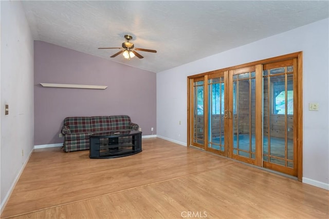 unfurnished room with ceiling fan, vaulted ceiling, light wood-type flooring, and french doors