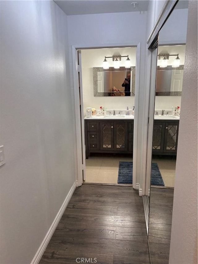 hallway with dark hardwood / wood-style flooring and sink