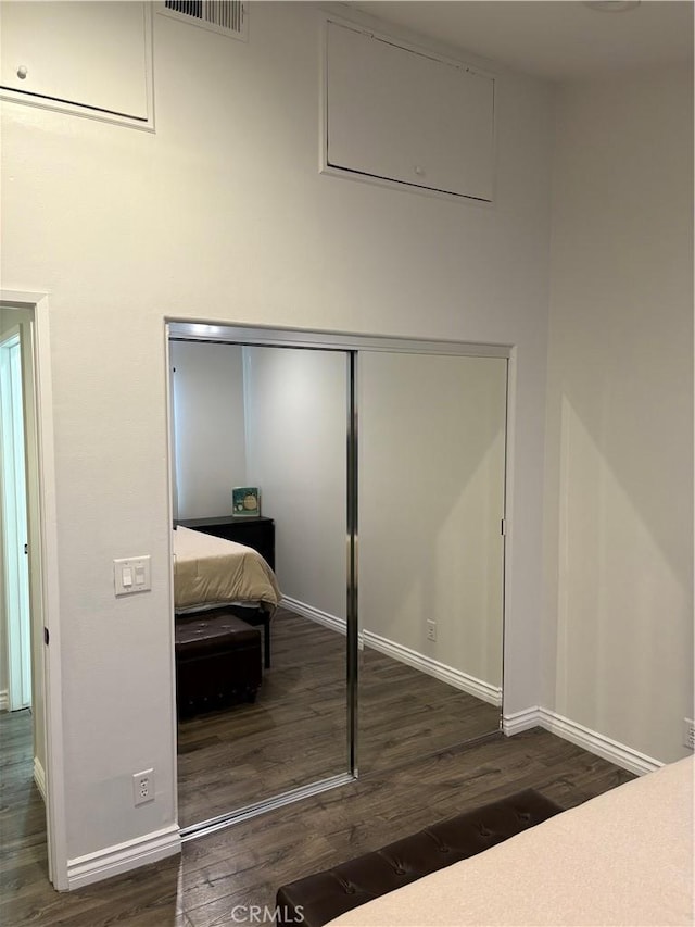 bedroom featuring dark wood-type flooring and a closet