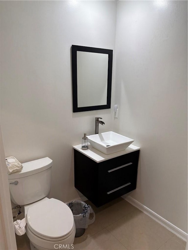 bathroom with vanity, toilet, and tile patterned flooring