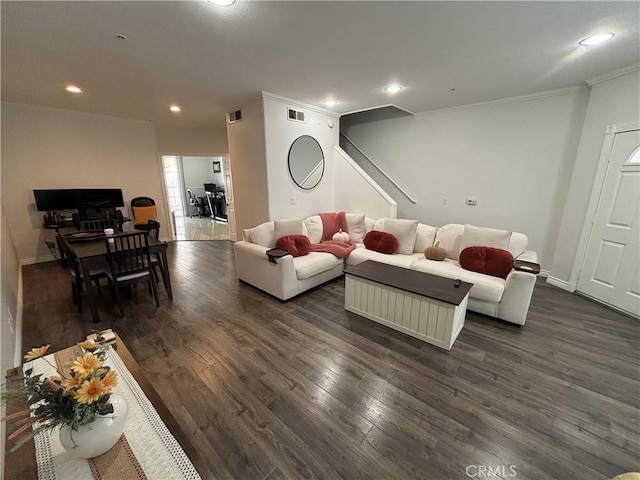 living room featuring ornamental molding and dark hardwood / wood-style floors