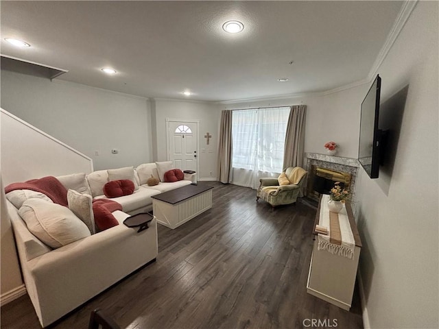 living room with crown molding, dark hardwood / wood-style floors, and a high end fireplace