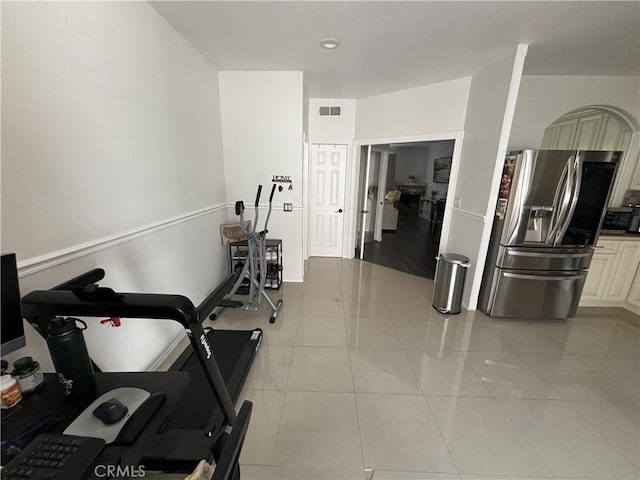 workout room featuring light tile patterned floors