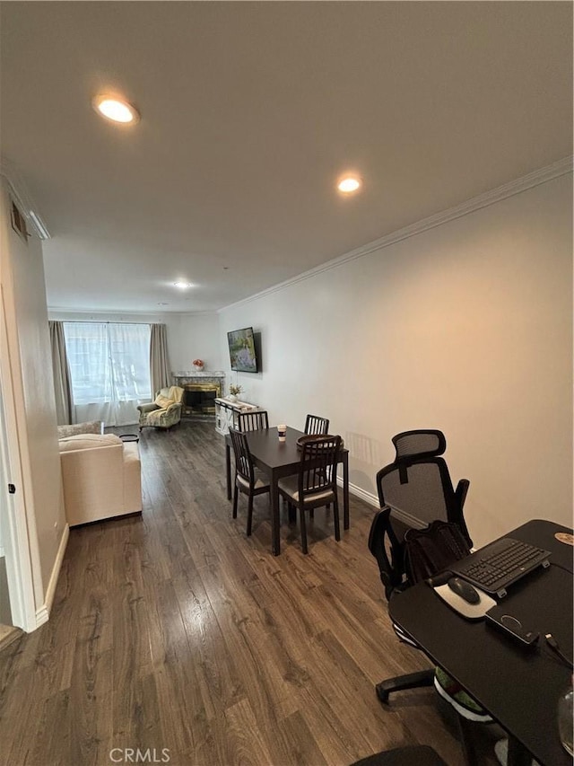 dining room with dark hardwood / wood-style flooring and ornamental molding