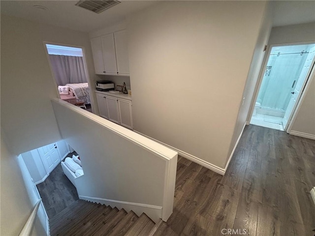 stairs featuring hardwood / wood-style floors and sink