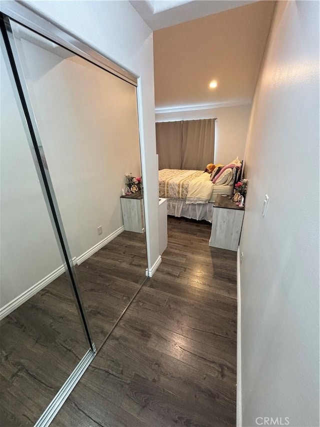 corridor with dark hardwood / wood-style flooring