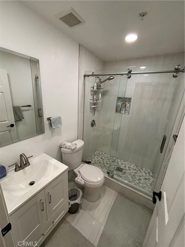 bathroom with vanity, toilet, and an enclosed shower