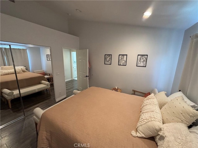 bedroom featuring dark wood-type flooring and high vaulted ceiling