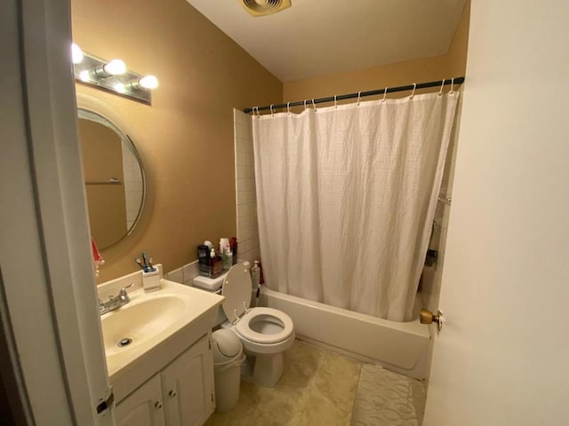 full bathroom featuring toilet, vanity, and shower / bath combo with shower curtain