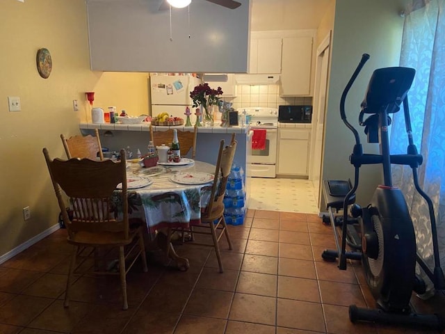 tiled dining room featuring ceiling fan