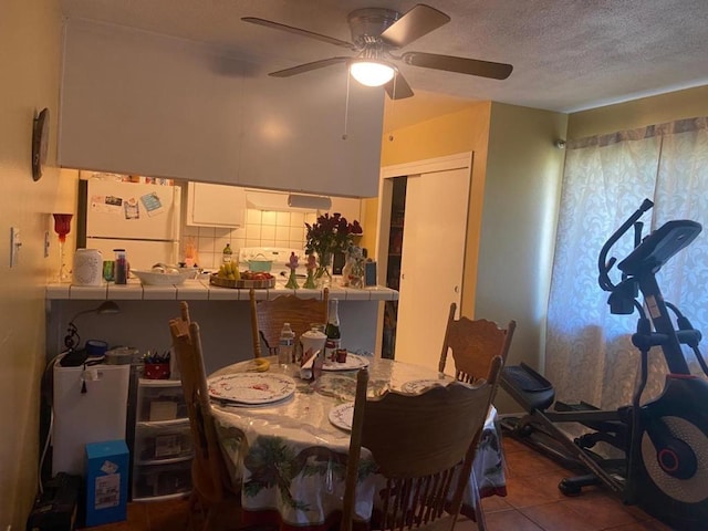 tiled dining room with ceiling fan