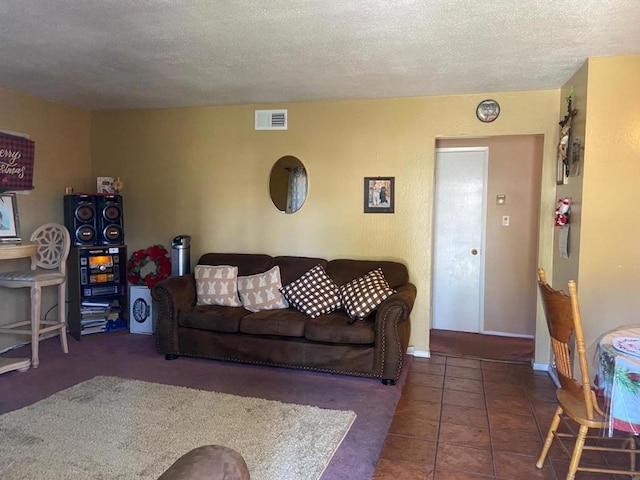 tiled living room with a textured ceiling