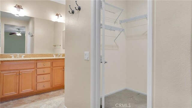 bathroom featuring ceiling fan and vanity