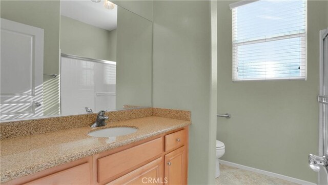 bathroom featuring vanity, tile patterned flooring, a shower with door, and toilet