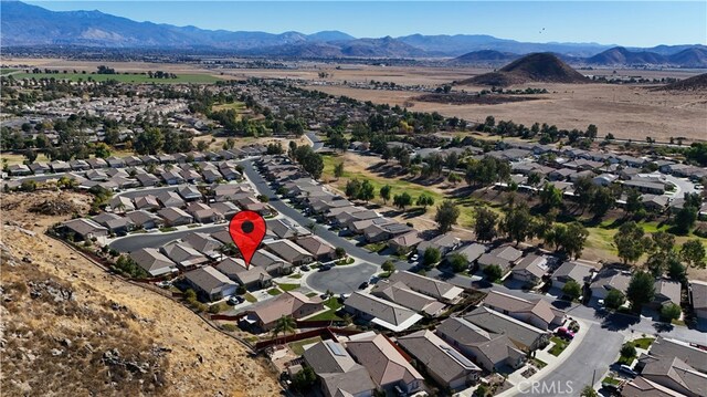 birds eye view of property featuring a mountain view