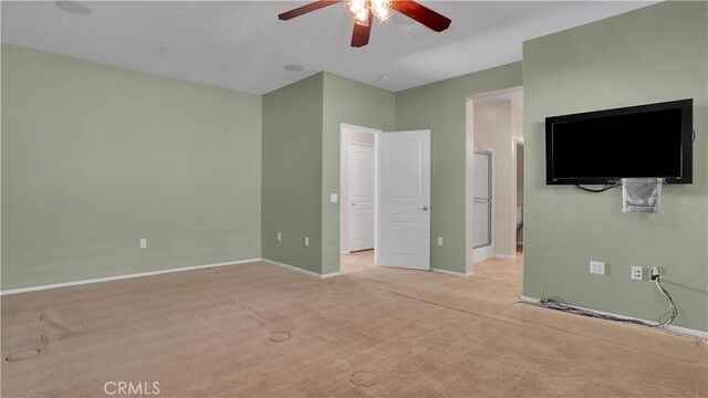 unfurnished bedroom featuring light colored carpet and ceiling fan