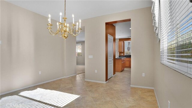 unfurnished dining area with an inviting chandelier