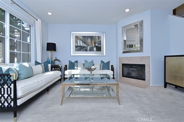 living room featuring light carpet and a fireplace