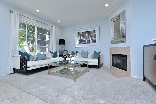 living room featuring light carpet and a tile fireplace