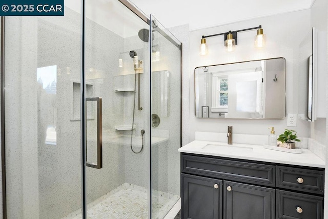 bathroom featuring vanity and a shower with door