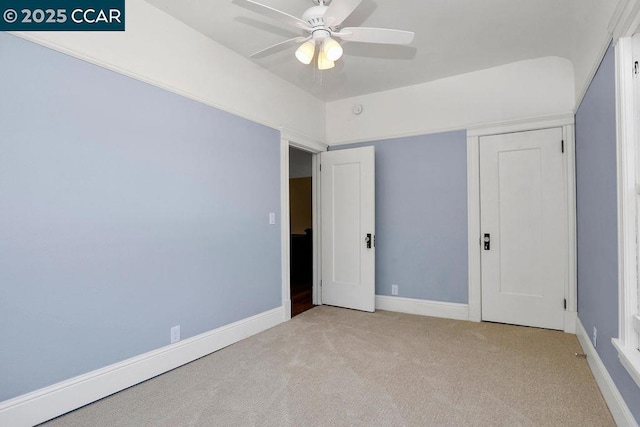 unfurnished bedroom with ceiling fan and light colored carpet