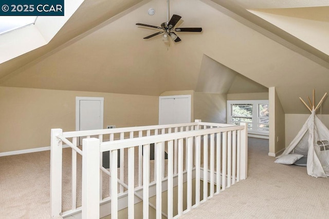 corridor with carpet flooring and lofted ceiling