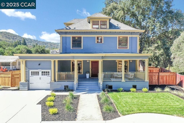 view of front of home with a front lawn, a mountain view, and covered porch