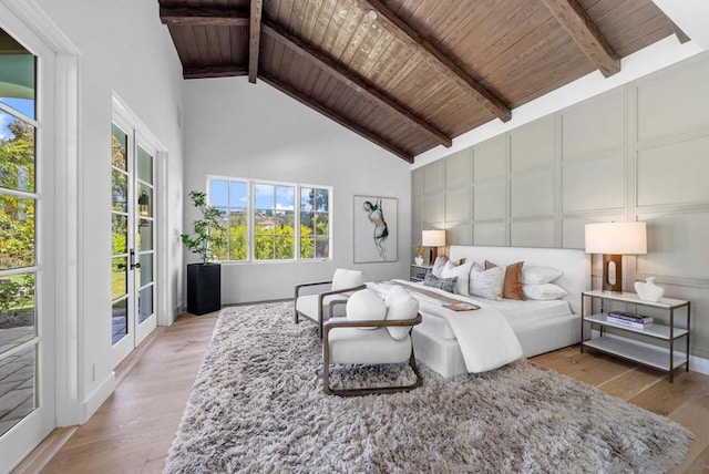 bedroom featuring wood ceiling, beam ceiling, light hardwood / wood-style floors, and access to outside