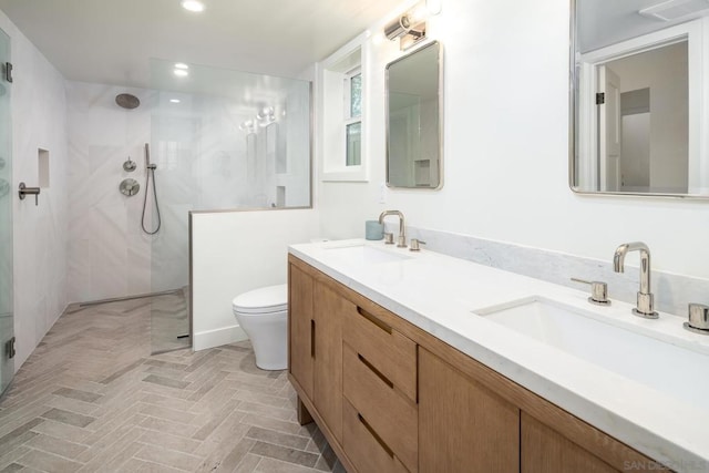 bathroom featuring vanity, toilet, and walk in shower