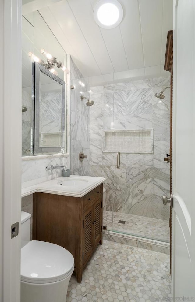 bathroom featuring vanity, toilet, and walk in shower