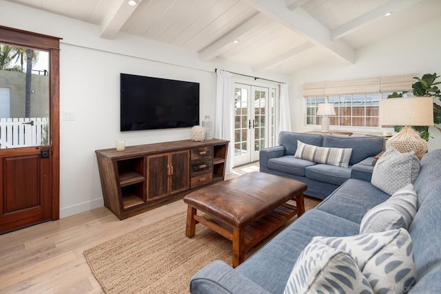 living room featuring lofted ceiling with beams, french doors, and light hardwood / wood-style flooring