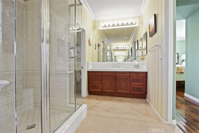 bathroom with vanity, an enclosed shower, tile patterned flooring, and ornamental molding