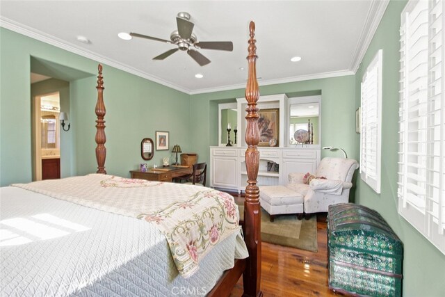 bedroom featuring crown molding, ceiling fan, ensuite bath, and hardwood / wood-style flooring