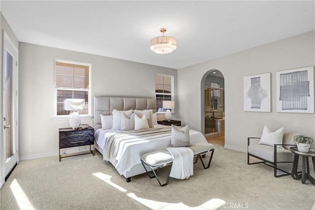 carpeted bedroom featuring connected bathroom