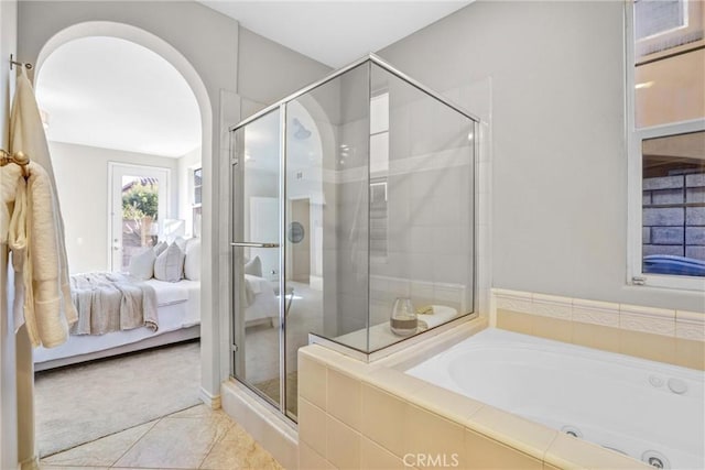 bathroom featuring tile patterned flooring and shower with separate bathtub